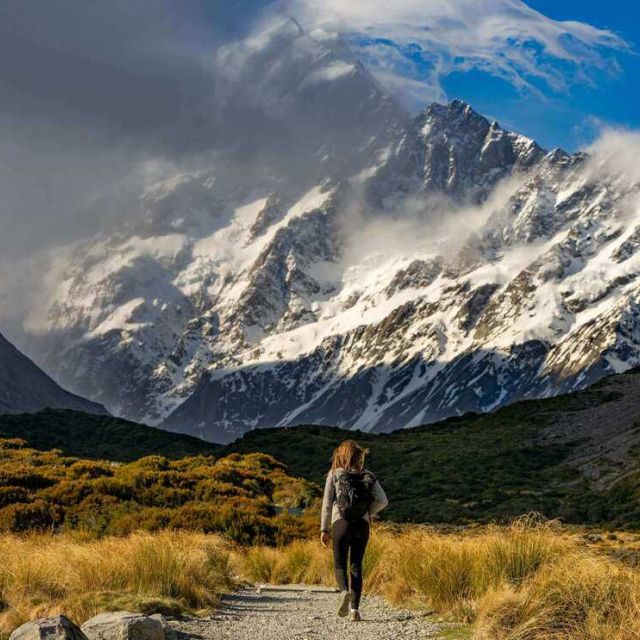 Iso republic hiker approaches snow capped mountains free stock photo